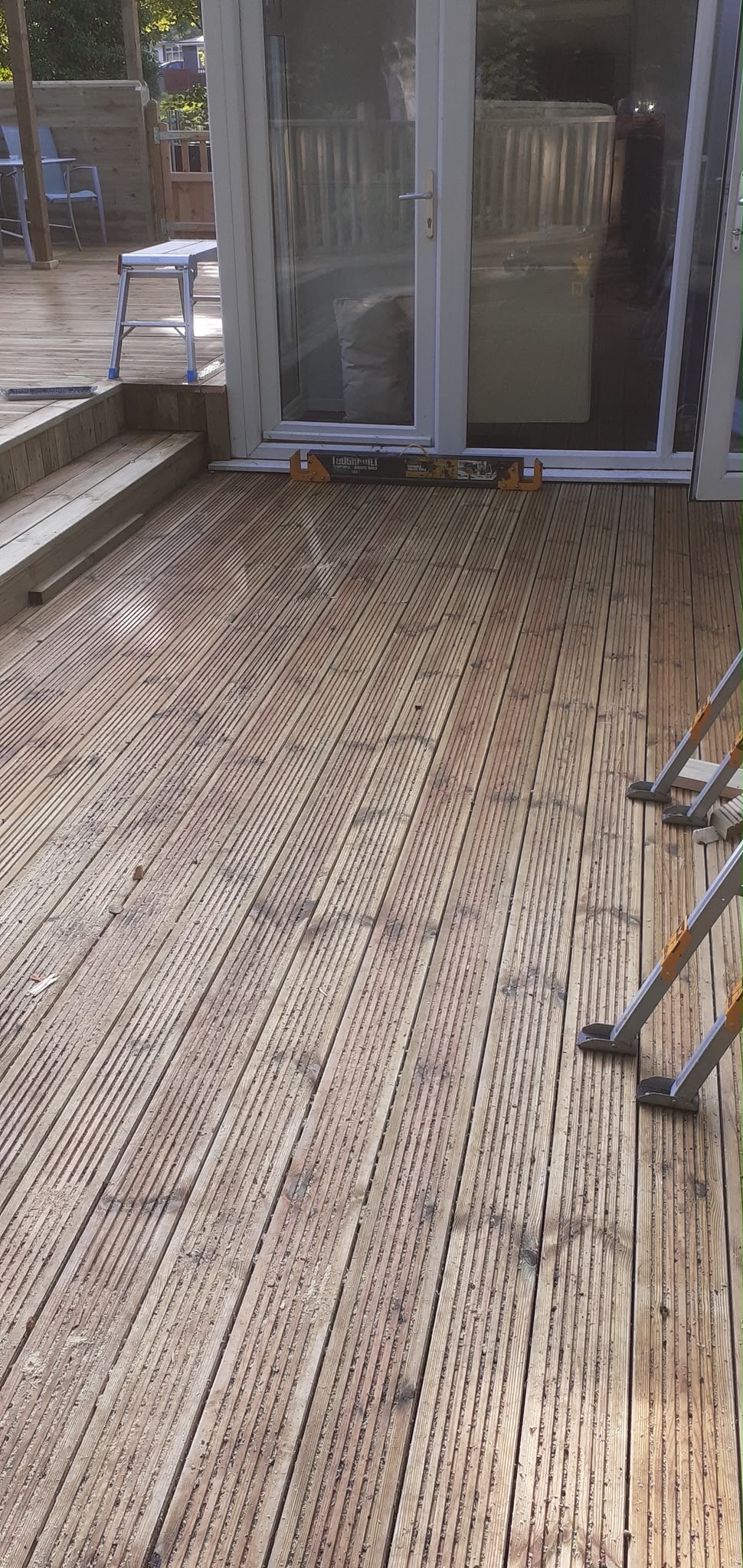 Grooved timber decking terrace installation outside patio doors
