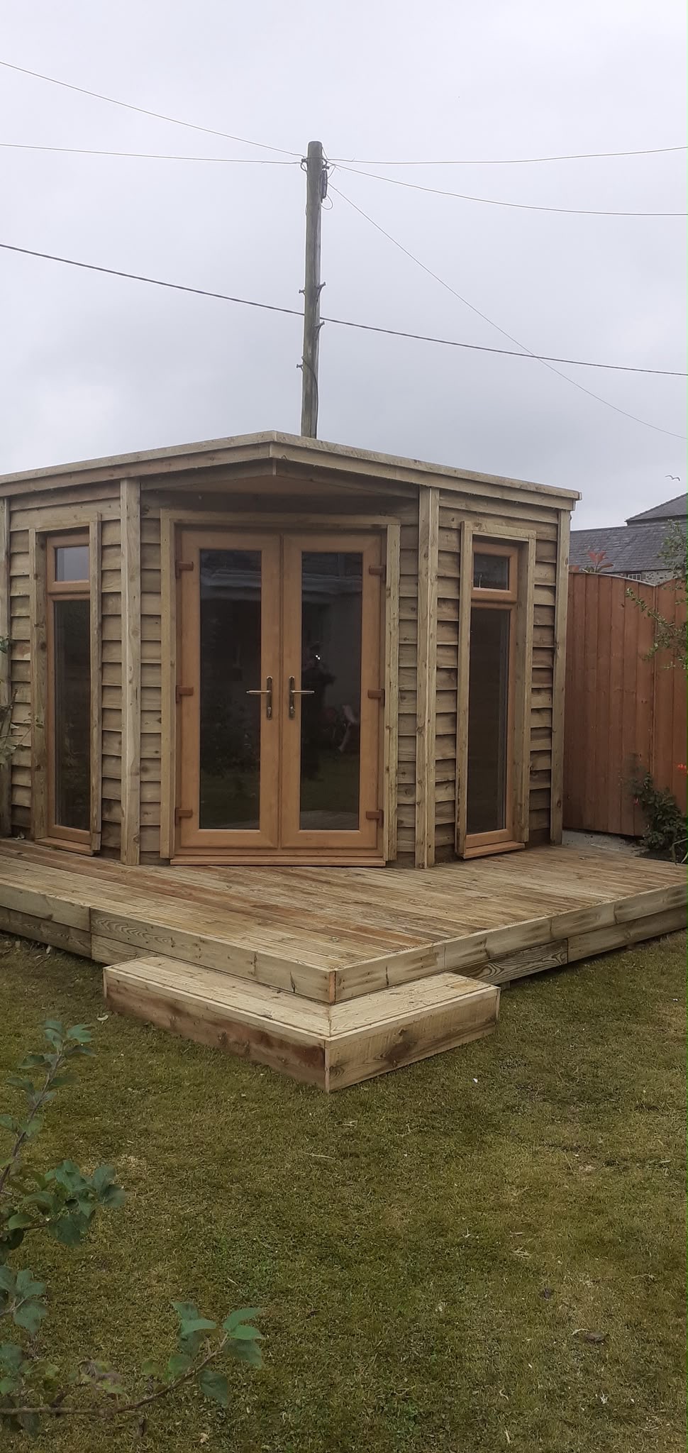 Custom timber garden room and wooden step deck in Anglesey